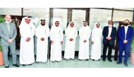 Officials of QU and Aryan Properties pose after signing the MoU.