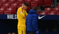Barcelona's Spanish defender Gerard Pique (L) reacts as he walks off the pitch after getting injured during the Spanish League football match between Club Atletico de Madrid and FC Barcelona at the Wanda Metropolitano stadium in Madrid on November 21, 202