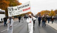 Two demonstrators walk with a banner reading 