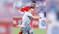 Al Sadd's Santi Cazorla vies for the ball with an Al Arabi player during yesterday's match.