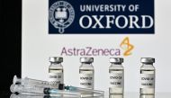 An illustration picture shows vials with Covid-19 Vaccine stickers attached and syringes, with the logo of the University of Oxford and its partner British pharmaceutical company AstraZeneca, on November 17, 2020. / AFP / JUSTIN TALLIS