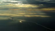In this file photo taken on August 05, 2010 In this photograph taken on August 5, 2010 during an aerial inspection organized by Greenpeace, the sun rises over Jambi province in Sumatra island. Greenhouse gases in the atmosphere, the main driver of climate