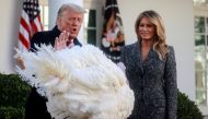US President Donald Trump stands with first lady Melania Trump as he pardons the National Thanksgiving Turkey 