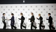 Members of K-pop boy band BTS pose for photographs during a news conference promoting their new album 