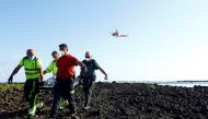 Rescue workers carry the body of a dead person after a boat with 35 migrants from the Maghreb region capsized in the beach of Orzola, in the Canary Island of Lanzarote. Reuters/Borja Suarez