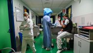 Nurse Care Coordinator, Silvana Di Florio (C), wearing protective gear, prepares to enter in the COVID-19 Intensive Care Unit (ICU) of the Tor Vergata hospital on November 24, 2020 in Rome.  AFP / ANDREAS SOLARO