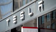 In this file photo taken on August 8, 2018 The Tesla logo is seen outside of their showroom in Washington, DC. Tesla's market value soared to more than $500 billion Tuesday ahead of its listing on the S&P 500, with its stock finishing up 6.4 percent or by