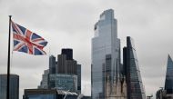 A Union Flag flutters in the wind near office buildings in the City of London in London on November 25, 2020. / AFP / Tolga Akmen
