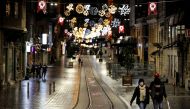 Couple walks along Istiklal Street at the popular touristic neighbourhood of Beyoglu after a partial weekend curfew started during the COVID-19 outbreak in Istanbul, Turkey, November 21, 2020. REUTERS/Umit Bektas
