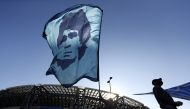 A person waves a Diego Maradona flag outside the Stadio San Paolo REUTERS/Yara Nardi