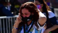 Diego Maradona's fans cry after paying their tribute to late football legend Diego Armando Maradona at the Government House in Buenos Aires, on November 26, 2020.   AFP / RONALDO SCHEMIDT