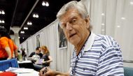 Actor David Prowse, who portrayed Darth Vader, signs autographs during the opening day of 