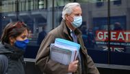 EU chief negotiator Michel Barnier wearing a protective face covering to combat the spread of the coronavirus, walks with his team to a conference centre to continue negotiations on a trade deal between the EU and the UK in London on November 29, 2020. AF