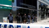 Police officers stand guard outside the building where Leopoldo Luque, the personal doctor of late Argentine soccer legend Diego Armando Maradona, has his office in Buenos Aires, Argentina November 29, 2020. REUTERS/Agustin Marcarian
