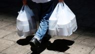 A man carries plastic bags containing take-away food after the government banned dine-in services, following the coronavirus disease (COVID-19) outbreak in Hong Kong, China July 29, 2020. REUTERS/Tyrone Siu/File Photo
