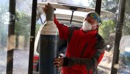Miralem Sabic carries oxygen bottles from his private van to an improvised coronavirus disease (COVID-19) hospital in Konjic, Bosnia and Herzegovina, November 27, 2020. Picture taken November 27, 2020. REUTERS/Dado Ruvic