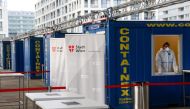 A healthcare worker wearing protective equipment is seen in a container as he waits for participants in rapid antigen testing at a mass testing station, as the spread of the coronavirus disease (COVID-19) continues, in Vienna, Austria November 30, 2020. R