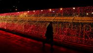 A man walks past a part of one kilometre-long Christmas illuminations with the colours of the Spanish flag, amid the coronavirus disease (COVID-19) outbreak in Madrid, Spain, November 26, 2020. REUTERS/Sergio Perez
