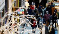 FILE PHOTO: People wear protective face masks as they walk beside Christmas decorations at a shopping mall amid the coronavirus disease (COVID-19) outbreak in Berlin, Germany, November 21, 2020. REUTERS/Fabrizio Bensch/File Photo
