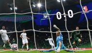 FK Krasnodar's Swedish forward Marcus Berg scores the opening goal past Rennes' French goalkeeper Romain Salin during the UEFA Champions League football match between FK Krasnodar and Rennes at the Krasnodar stadium in Krasnodar on December 2, 2020. / AFP