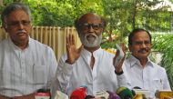 Indian actor Rajinikanth (C) addresses the media representatives in front of his residence in Chennai on December 3, 2020. AFP 