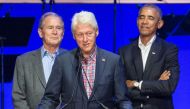 (FILES) In this file photo taken on October 21, 2017, (L-R) former US Presidents George W. Bush, Bill Clinton, and Barack Obama attend the Hurricane Relief concert in College Station, Texas. Obama, Bush and Bill Clinton are volunteering to take a coronavi