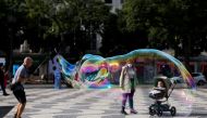 FILE PHOTO: A street artist performs with soap bubbles at Rossio square during the coronavirus disease (COVID-19) outbreak, in downtown Lisbon, Portugal October 31, 2020. REUTERS/Rafael Marchante/File Photo
