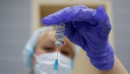 A medical worker fills a syringe with Sputnik V (Gam-COVID-Vac) vaccine before administering an injection during the vaccination against the coronavirus disease (COVID-19) at a clinic in the town of Domodedovo near Moscow, Russia December 3, 2020. REUTERS