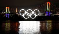 FILE PHOTO: The giant Olympic rings which were temporarily taken down in August for maintenance are illuminated after being reinstalled at the waterfront area at Odaiba Marine Park, amid the coronavirus disease (COVID 19) outbreak, in Tokyo, Japan Decembe