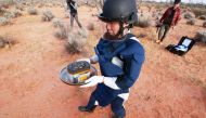 This handout photograph taken and released by the Japan Aerospace Exploration Agency (JAXA) on December 6, 2020 shows recovery operations of the re-entry capsule, carrying samples collected from a distant asteroid after being dropped off by Japanese space