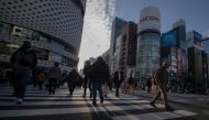 People cross a street in the Ginza shopping district in Tokyo on December 6, 2020. / AFP / Kazuhiro Nogi