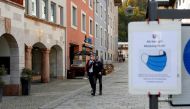 FILE PHOTO: Men wearing protective face masks walk after residents of the Berchtesgadener Land district of Bavaria will not be able to leave their homes from October 20, 2020, without a valid reason for two weeks, making it the first area in Germany to go