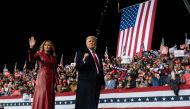 US President Donald Trump leaves the stage with First Lady Melania Trump at the end of a rally to support Republican Senate candidates at Valdosta Regional Airport in Valdosta, Georgia on December 5, 2020. / AFP / ANDREW CABALLERO-REYNOLDS
