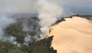 An aerial view shows smoke following a massive bushfire in Australia's Fraser Island, also known by its indigenous name K'gari, November 30, 2020, in this picture obtained from social media. Queensland Fire and Emergency Services via REUTERS/File Photo