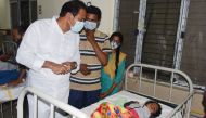 In this handout photo take and released by the Public Relations Department Government of Andhra Pradesh on December 6, 2020, Andhra Pradesh Health minister Alla Nani (L) visits patients receiving medical care for a mystery illness at a government hospital