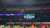 Football players and referees kneel on the pitch against racism before the UEFA Champions League group H football match between Paris Saint-Germain (PSG) and Istanbul Basaksehir FK at the Parc des Princes stadium in Paris, on December 9, 2020. / AFP / FRA
