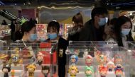 People wearing masks, following the coronavirus disease (COVDI-19) outbreak, are seen inside a store of Chinese toy maker Pop Mart at a shopping mall in Beijing, China December 9, 2020. Picture taken December 9, 2020. REUTERS/Tingshu Wang