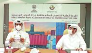 Eng. Fahad Rashid Al Kaabi (right), CEO of Manateq looks on, while a senior official from the Ministry of Commerce and Industry showing one of the winners of a land plot for Birkat Al Awamer Logistics Park, yesterday. 
