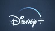 In this file photo taken on November 13, 2019 the Disney+ logo is seen on the backdrop for the World Premiere of 