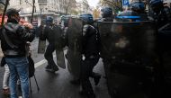 A protester films with his mobile phone the riot mobile gendarmes during a demonstration in Paris on December 12, 2020, against the 'global security' draft law. AFP / Christophe ARCHAMBAULT