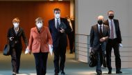 German Chancellor Angela Merkel, Bavarian State Premier Markus Soeder, German Finance Minister Olaf Scholz and Berlin Mayor Michael Mueller arrive for a news conference following talks with state leaders to discuss anti-coronavirus measures at the Chancel