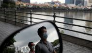 People wearing face masks as a precaution against the coronavirus disease (COVID-19) walk during lunch hour at the central business district in Singapore, December 14, 2020. REUTERS/Edgar Su/File Photo
