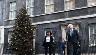 Britain's Prime Minister Boris Johnson (R) leaves 10 Downing Street in London on December 15, 2020 with Director of the Number 10 Policy Unit Munira Mirza (L) to attend the weekly cabinet meeting held at the nearby Foreign, Commonwealth and Development Of