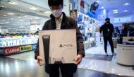 In a photo taken on November 12, 2020, a customer walks away after purchasing the new Sony Playstation PS5 in Seoul after Sony launched the new console in select markets around the world. / AFP / Ed JONES