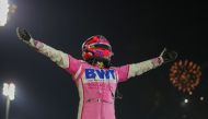 In this file photograph taken on December 6, 2020, Racing Point's Mexican driver Sergio Perez celebrates winning the Sakhir Formula One Grand Prix at the Bahrain International Circuit in the city of Sakhir. Mexican driver Sergio Perez will replace Alexand
