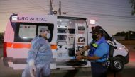 A paramedic is disinfected after transferring a patient infected with Covid-19 in Panama City on December 14, 2020. AFP / STR