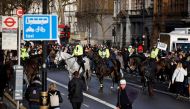 Mounted police officers attempt to prevent protesters march up Whitehall after they gather in Parliament Square at an anti-lockdown demonstration, 