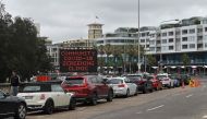People queue in cars at a Covid-19 drive-through testing centre at Bondi Beach in Sydney on December 20, 2020. / AFP / Steven Saphore