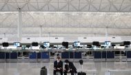Pilots wearing face masks to avoid the spread of the coronavirus are seen at the Hong Kong International Airport, in Hong Kong, China May 7, 2020. Picture taken May 7, 2020. REUTERS/Tyrone Siu/File Photo