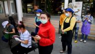 Migrant workers queue to talk with the public health authorities for a COVID-19 investigation at a fresh market, amid the coronavirus disease (COVID-19) outbreak, in Bangkok, Thailand, December 22, 2020. Reuters/Chalinee Thirasupa
